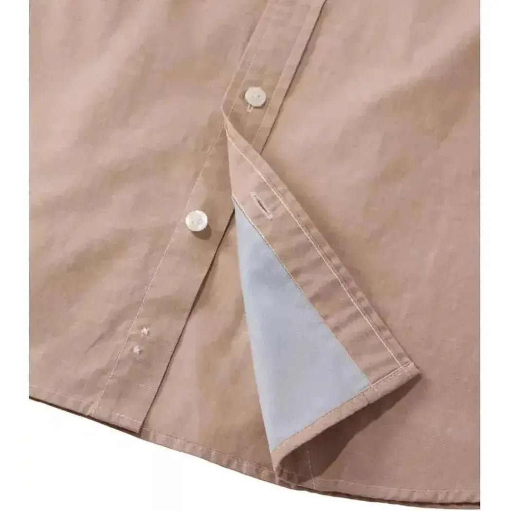 A close-up of the L.L.Bean Men's Comfort Stretch Performance Chambray Shirt in Camel Brown showing the button placket and light blue inner lining.