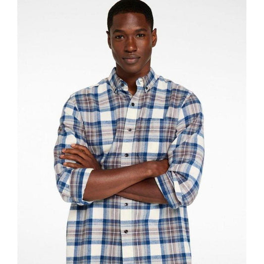 A model wearing the L.L.Bean Men's Long Sleeve Scotch Plaid Flannel Shirt in Indigo Tartan stands with arms crossed against a plain white background.