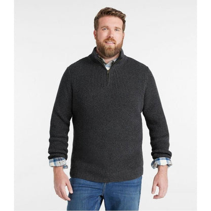 A front view of the L.L.Bean Men's Organic Cotton Waffle Quarter Zip Sweater in Faded Black on a model wearing blue jeans against a white background.