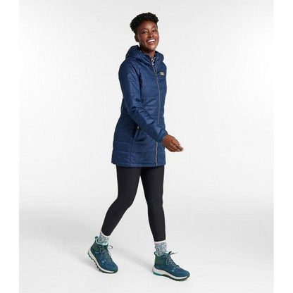 Side view of the L.L.Bean Women's Mountain Classic Puffer Coat in Nautical Navy on a model against a white background.