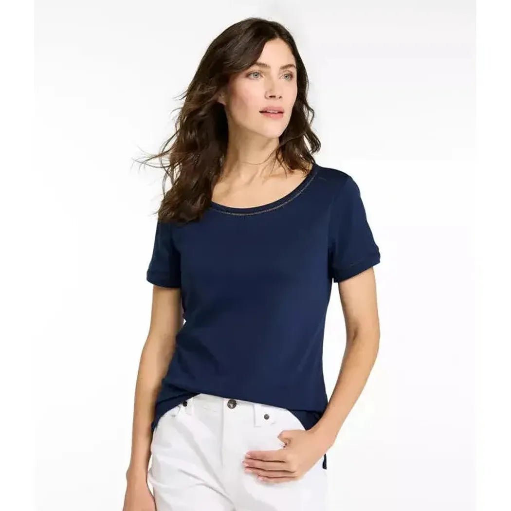 A front view of the L.L.Bean Women's Pima Cotton Tee, Short-Sleeve Jewelneck in Raven Blue on a model wearing white pants against a white background.