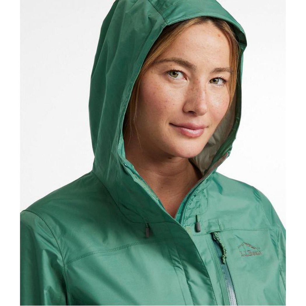 A woman wearing the L.L.Bean Women's Regular Trail Model Rain Jacket in Lake color, shown from the front with the hood up against a plain white background.