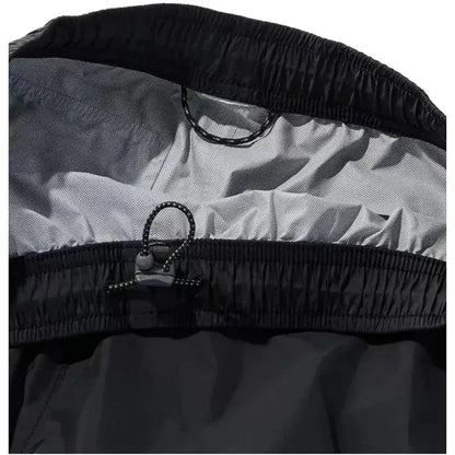 Close-up of the L.L.Bean Women's Trail Model Rain Pants in Black showing the elastic waistband and drawcord closure against a white background.