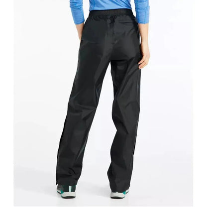 Back view of the L.L.Bean Women's Trail Model Rain Pants in Black, showing the elastic waistband and pockets, with a model wearing them against a white background.