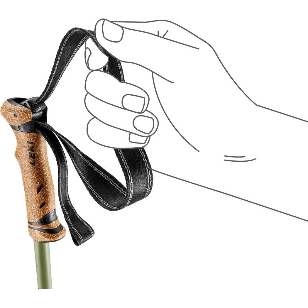 A hand grips the black strap of the Leki Legacy Lite trekking pole with a brown cork handle, shown from a side angle against a white background.