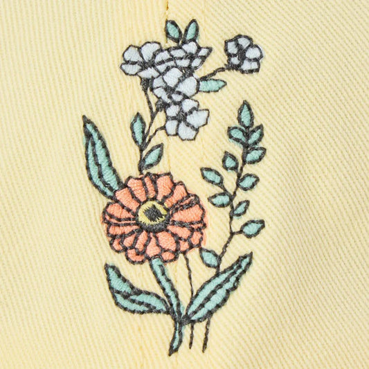 A close-up of the Life is Good Adult Unisex Zinnia Bouquet Chillcap in Birch White, showing embroidered flowers on a light background.