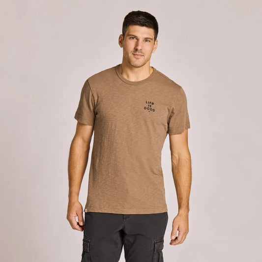 A front view of the Life is Good Men's Mountain Landscape Short Sleeve Slub Slim Fit Tee in Mushroom Brown on a model against a light background.