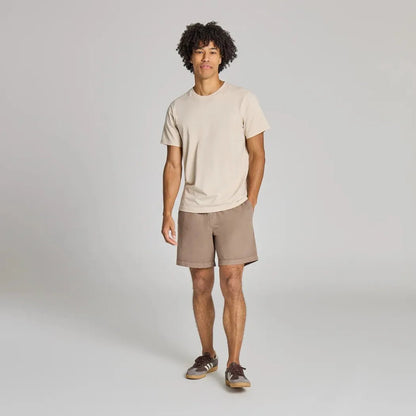 A model wearing the Life is Good Men's Solid Weekender Short in Mushroom Brown stands against a plain background.
