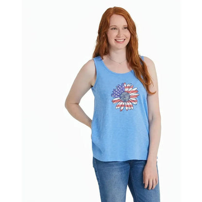 A woman wearing the Life is Good Women's America The Beautiful Daisy Textured Slub Tank in Cornflower Blue stands against a white background.