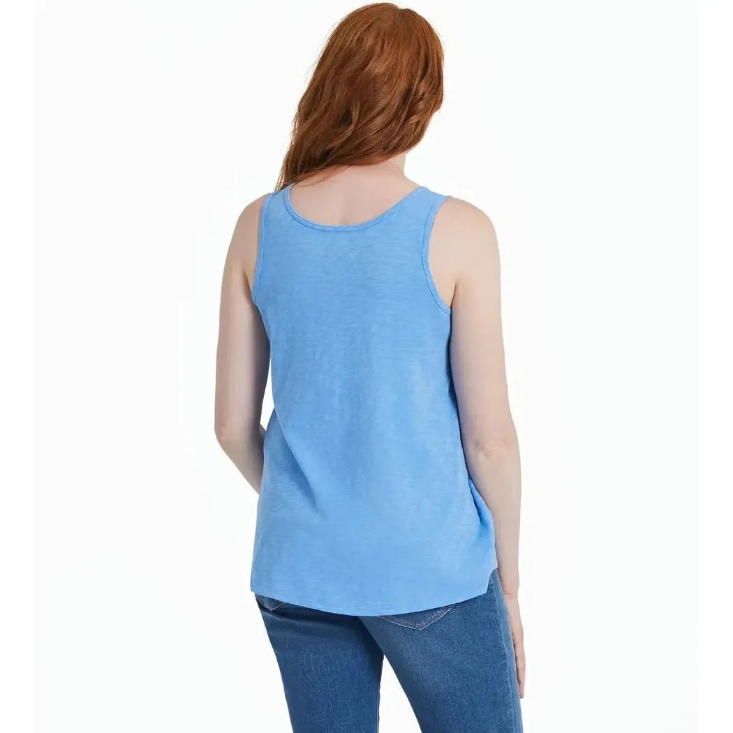 Back view of the Life is Good Women's America The Beautiful Daisy Textured Slub Tank in Cornflower Blue on a model wearing blue jeans against a white background.