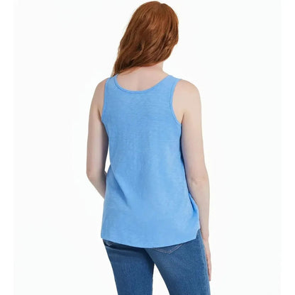 Back view of the Life is Good Women's America The Beautiful Daisy Textured Slub Tank in Cornflower Blue on a model wearing blue jeans against a white background.