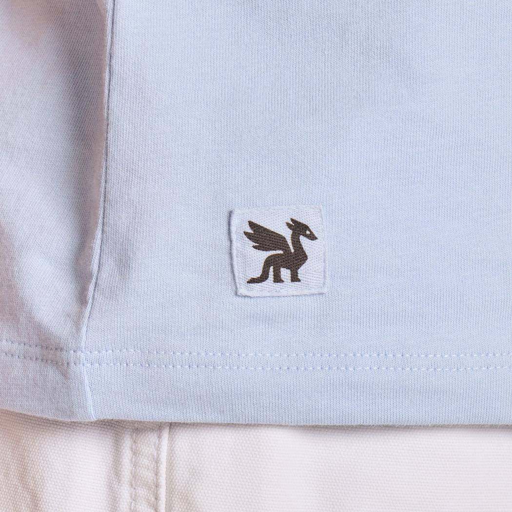 A close-up of the Life is Good Women's Forgetmenot Butterfly Short Sleeve Crusher Tee in Glacier Blue showing the small embroidered logo on the chest.