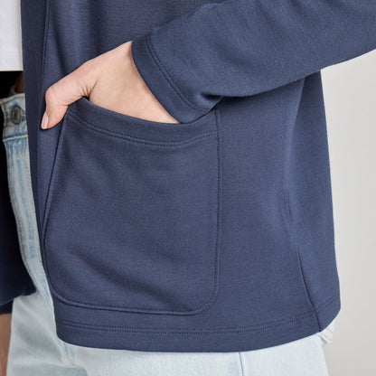 Side view of the Life is Good Women's Solid Soft Touch Open Cardigan in Inkwell Blue showing the front pocket and model wearing it.