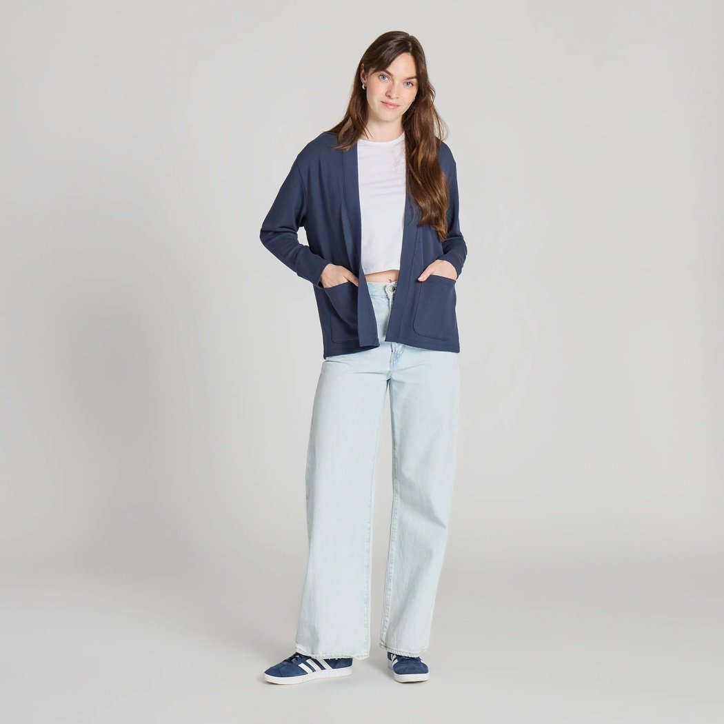 A model wearing the Life is Good Women's Solid Soft Touch Open Cardigan in Inkwell Blue stands against a plain background.
