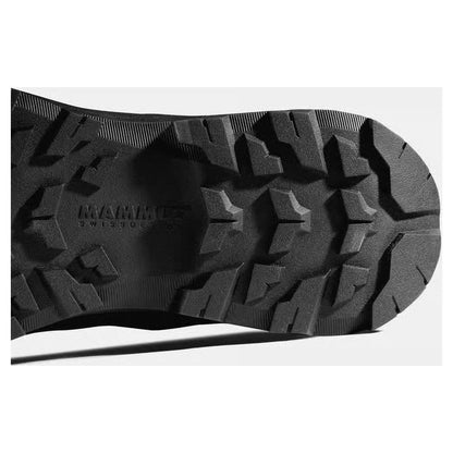 The sole of the Mammut Sertig III Low GTX Men shoe shows deep tread patterns and the brand name, photographed from below against a light background.