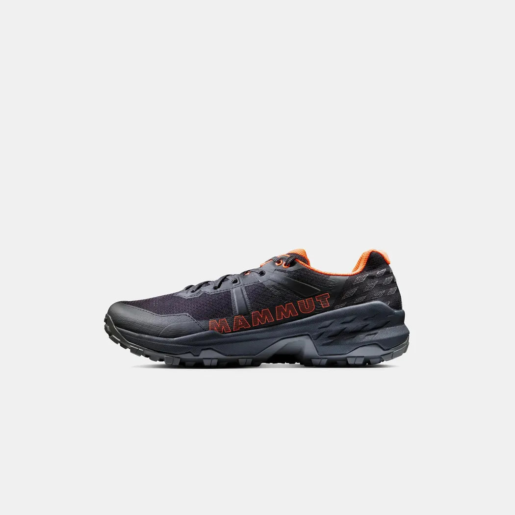 Side view of the Mammut Sertig II Low GTX Men in Black-Vibrant Orange with a rugged outsole against a plain background.