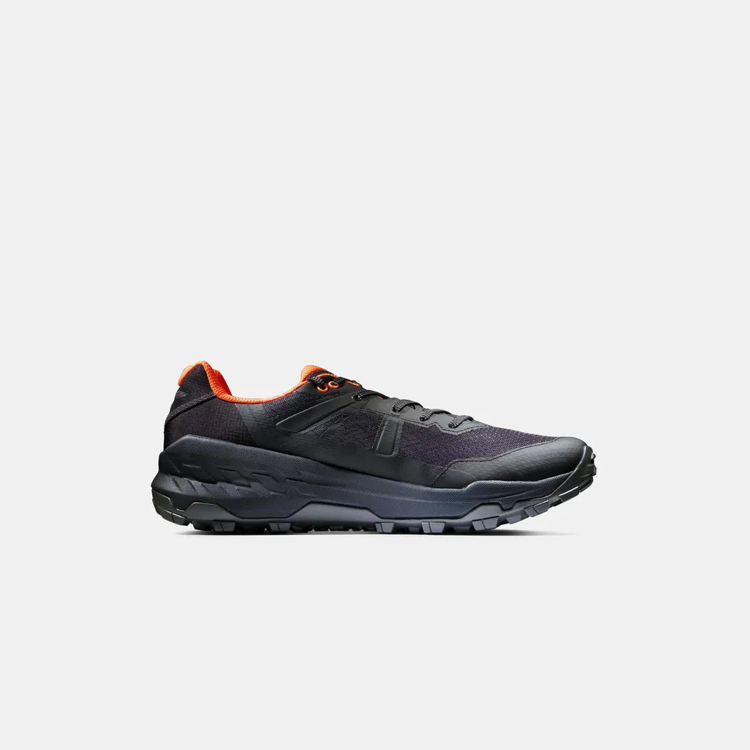 Side view of the Mammut Sports Group Sertig II Low GTX Men in Black-Vibrant Orange with a thick lugged outsole against a plain white background.