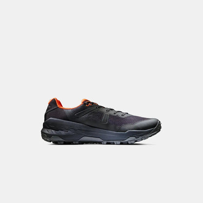 Side view of the Mammut Sports Group Sertig II Low GTX Men in Black-Vibrant Orange with a thick lugged outsole against a plain white background.