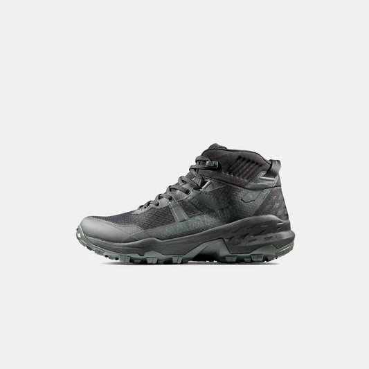 Side view of the Mammut Sports Group Sertig II Mid GTX Men in Black showing the lugged outsole against a white background.