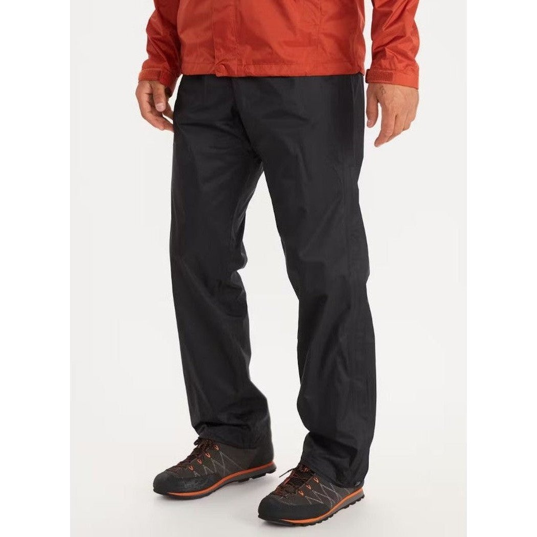 A front view of the Marmot Men's PreCip Eco Full Zip Pant in Black on a model wearing dark hiking shoes against a white background.