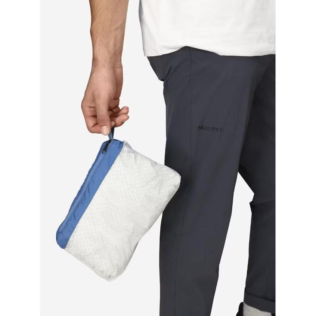 A man in Arctic Navy pants holds a small blue and white Marmot Men's PreCip Eco Jacket pouch in his hand.