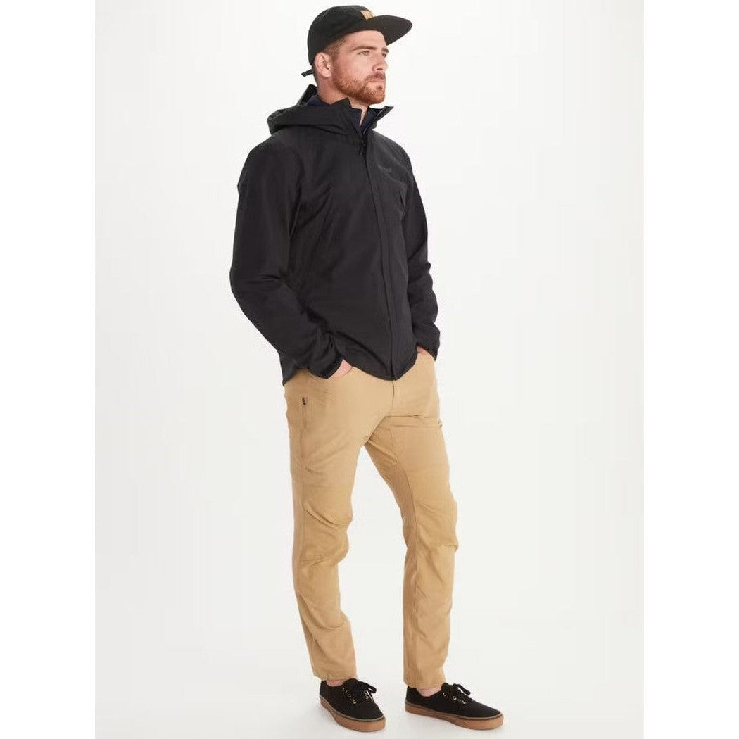 A man wearing the Marmot Men's PreCip Eco Pro Jacket in Black stands with hands in pockets against a white background.