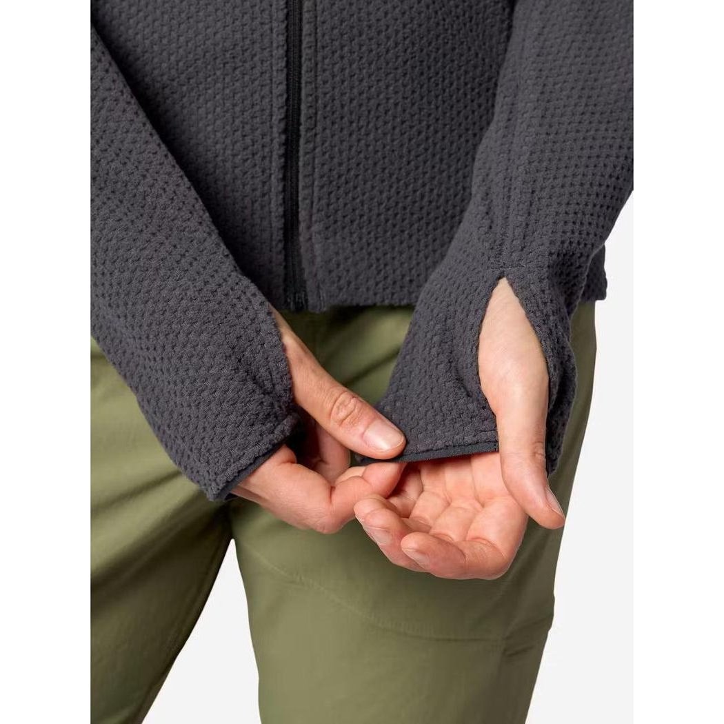 A close-up of the Marmot Women's AirFleece Jacket in Blackened, showing the textured fabric and cuffs on a model wearing olive pants.