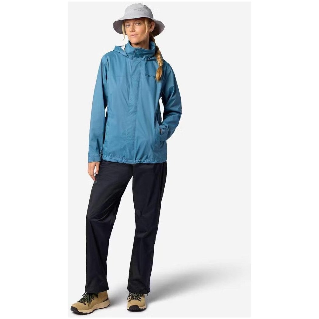 A woman wearing the Marmot Women's PreCip Evo Pant in Black stands against a plain white background.