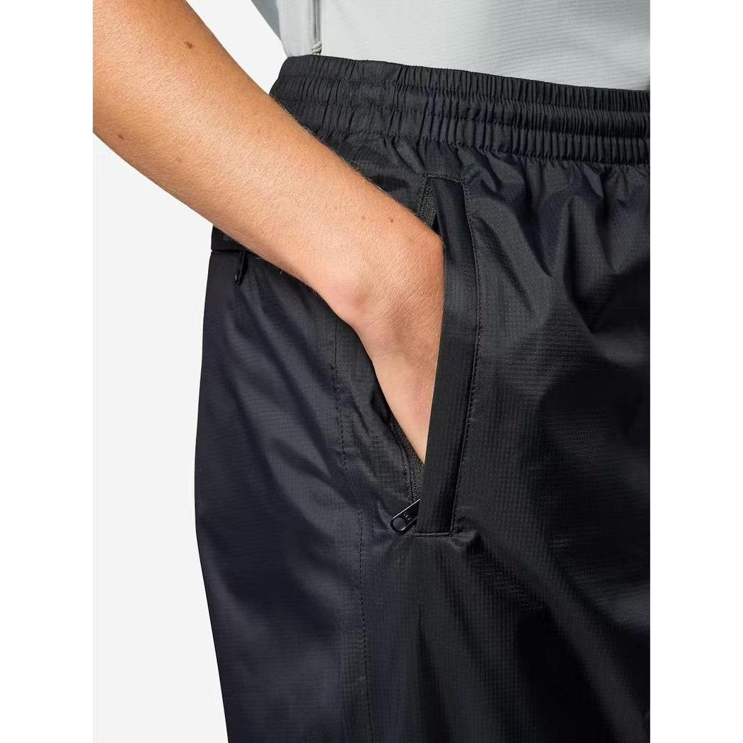 Side view of the Marmot Women's PreCip Evo Pant in Black showing the elastic waistband and front pocket against a light background.