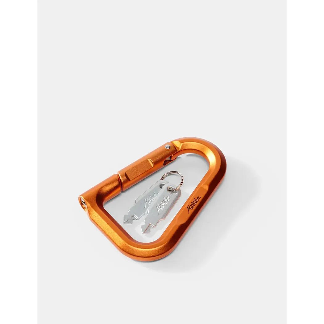 A top-down view of the Matador BetaLock in Canyon Orange with a silver keychain inside, set against a plain white background.