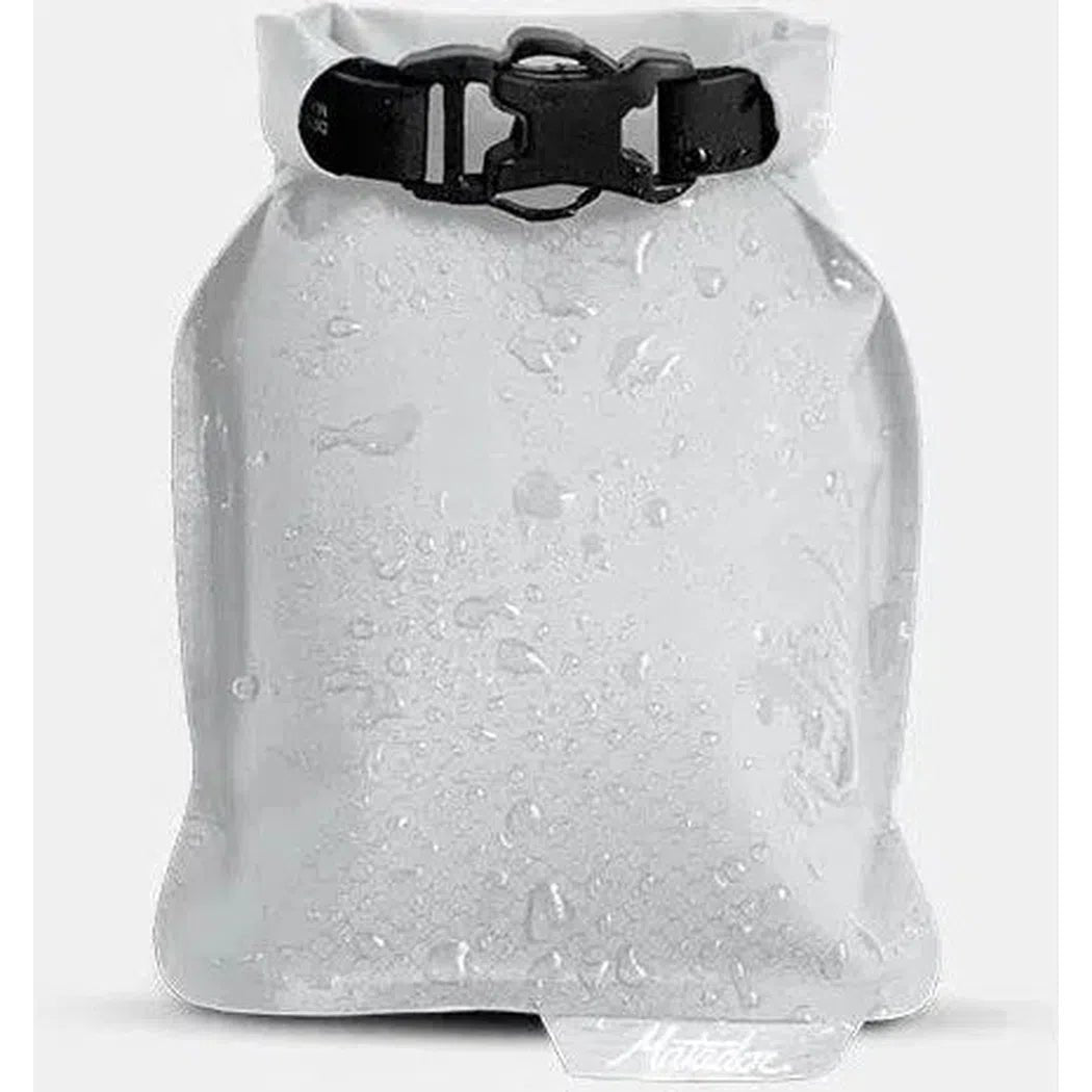 A front view of the Matador FlatPak Soap Bar Case in Arctic showing water droplets on the surface against a white background.