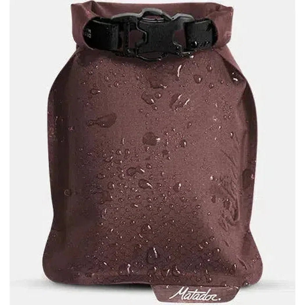A front view of the Matador FlatPak Soap Bar Case in Arctic color showing water droplets on the surface and the brand name at the bottom.