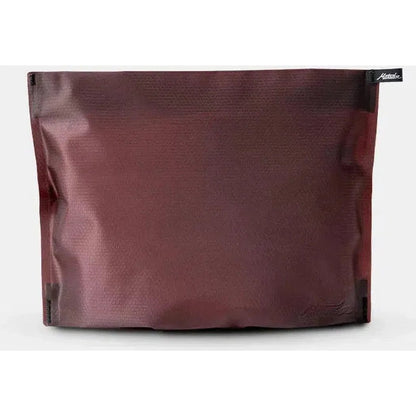 Front view of the Matador FlatPak Zipper Toiletry Case in Arctic White against a white background.