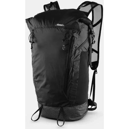 A front view of the Matador Freerain 22 Waterproof Packable Backpack in Black with mesh shoulder straps and a checkered bottom panel.