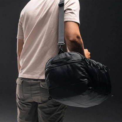 Back view of the Matador SEG 45 Travel Pack in Black showing the shoulder strap and large main compartment against a dark background.