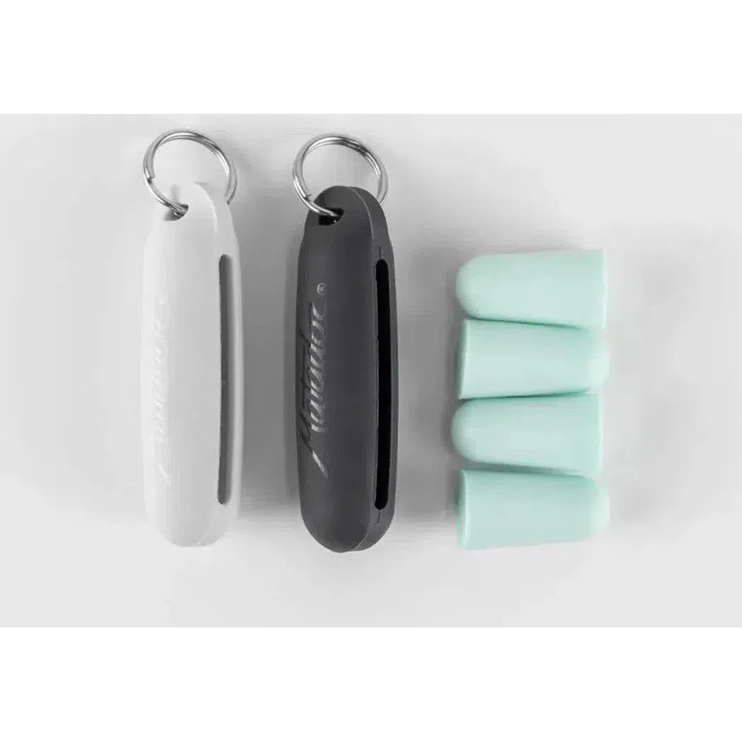 Two keychain-style cases and four mint-colored earplugs for the Matador Travel Earplugs Kit are displayed on a white background.