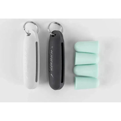 Two keychain-style cases and four mint-colored earplugs for the Matador Travel Earplugs Kit are displayed on a white background.