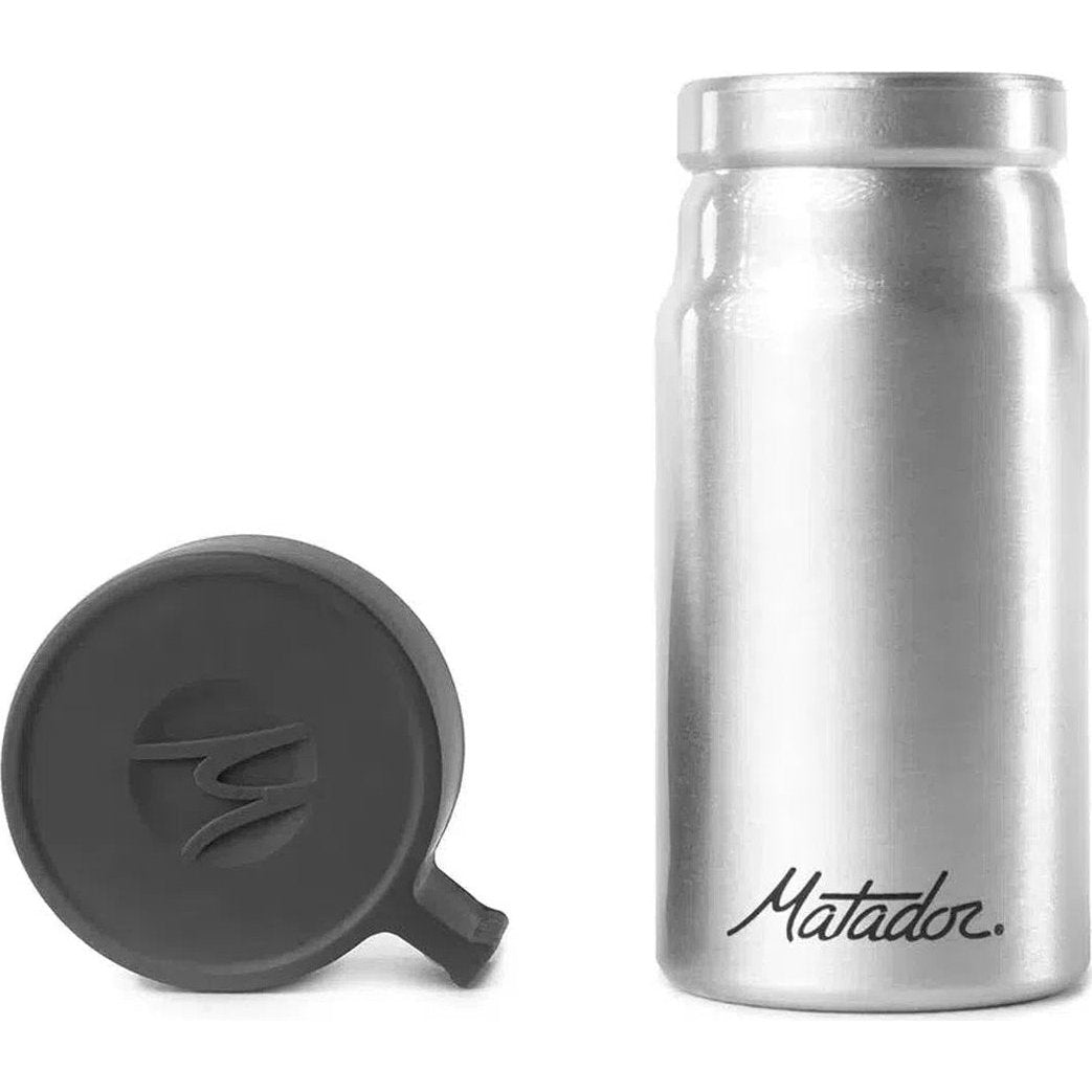 A side view of the Matador 40ml waterproof travel canister with its charcoal lid off, against a white background.