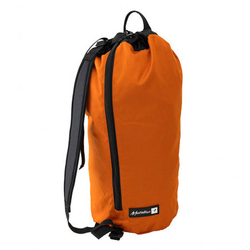 Side view of the Metolius Dirt Bag II in Rust showing the drawstring closure and black straps against a white background.