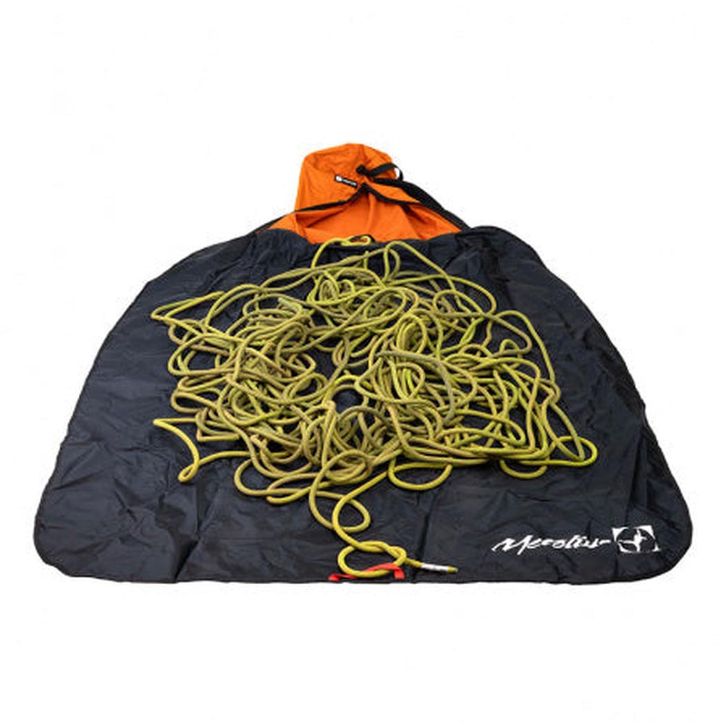 A top-down view of the Metolius Dirt Bag II in Rust showing a coiled yellow rope on a black bag with an orange top.