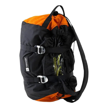 Side view of the Metolius Rope Master HC in Rust showing the buckle closure and rope compartment against a white background.