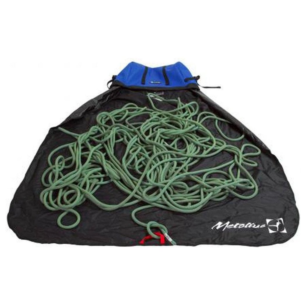A blue Metolius Ropemaster HC rope bag holds a green climbing rope on a black surface.
