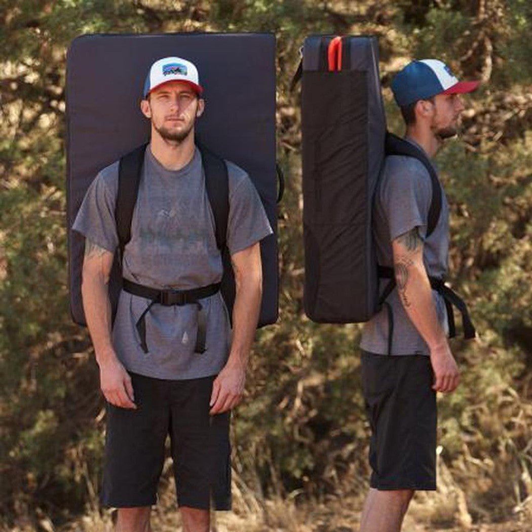 Two views of a man wearing the Metolius Session II Crash Pad in Black/Gray, showing front and side angles against a forest background.