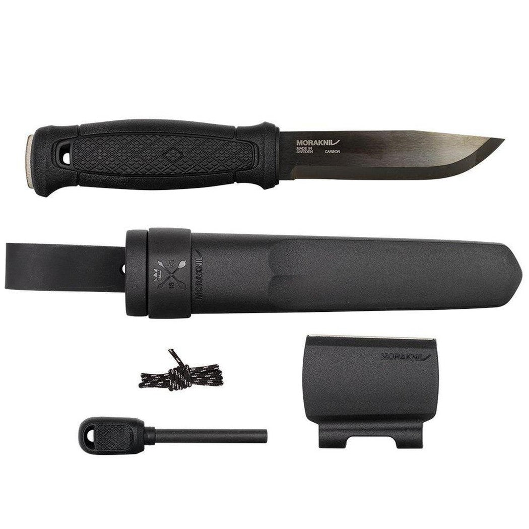 A top-down view of the Morakniv Garberg Survival Blackblade knife with its sheath, fire starter, and lanyard against a white background.