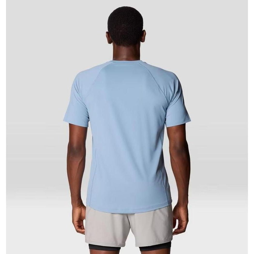 Back view of the Mountain Hardwear Men's Crater Lake Short Sleeve in Element color on a model wearing light gray shorts against a plain background.