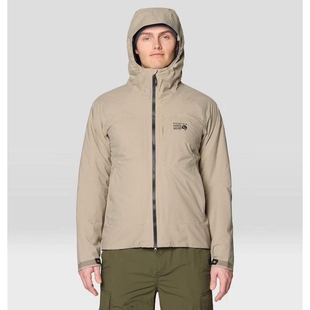 A front view of the Mountain Hardwear Men's Stretch Ozonic Insulated Jacket in Dunes with a hood, zippered front, and a model wearing olive pants against a light background.