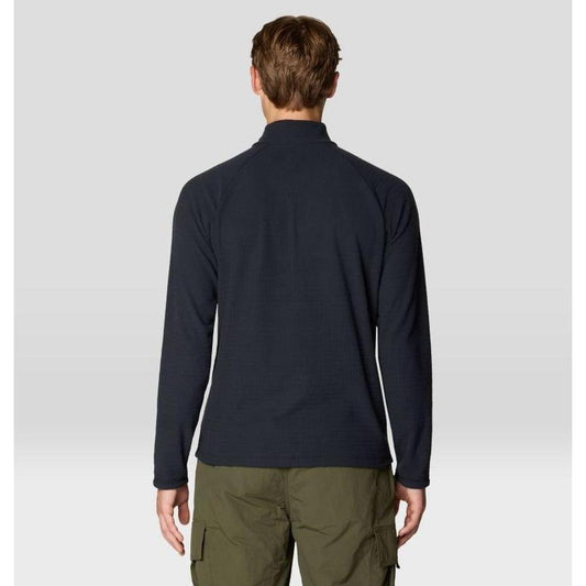 Back view of the Mountain Hardwear Men's Summit Grid Half Zip in Black on a model wearing olive cargo pants against a light gray background.
