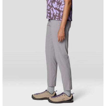 Side view of the Mountain Hardwear Women's Dynama Ankle Pant in Black, showing the cropped fit and model wearing it against a plain background.