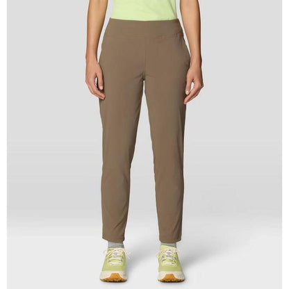 A front view of the Mountain Hardwear Women's Dynama Ankle Pant in Black on a model wearing light green sneakers against a plain background.