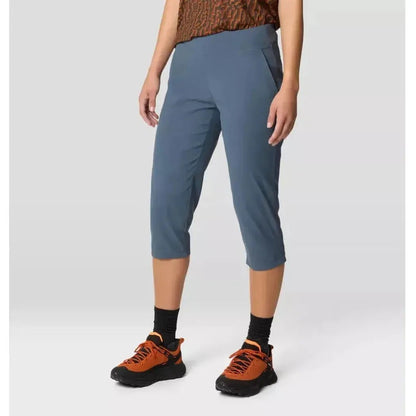 Side view of the Mountain Hardwear Women's Dynama Capri in Moon Blue showing the pocket and a model wearing them against a light background.